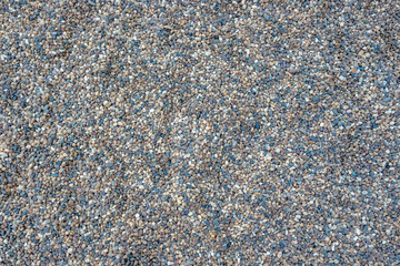 Textured of colorful crushed stones on the seashore.