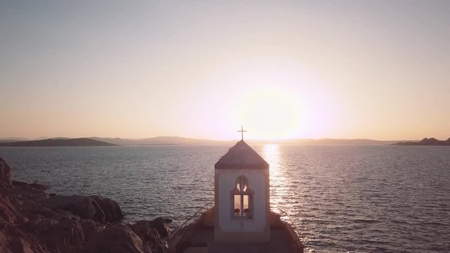 Aerial of a chapel on water. Camera moves to the subject. FullHD