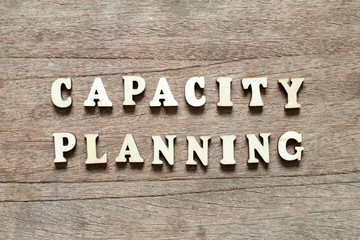 Letter block in word capacity planning on wood background