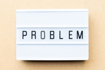 White lightbox with word problem on wood background