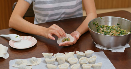 Woman make with chinese meat dumpling