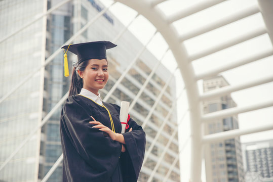 Graduate Student And Success Education In University Concept. Happy Asian Student Woman Graduate Diploma And MBA Degree In Asian College.