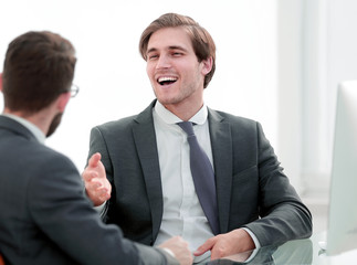 young business partners shake hands