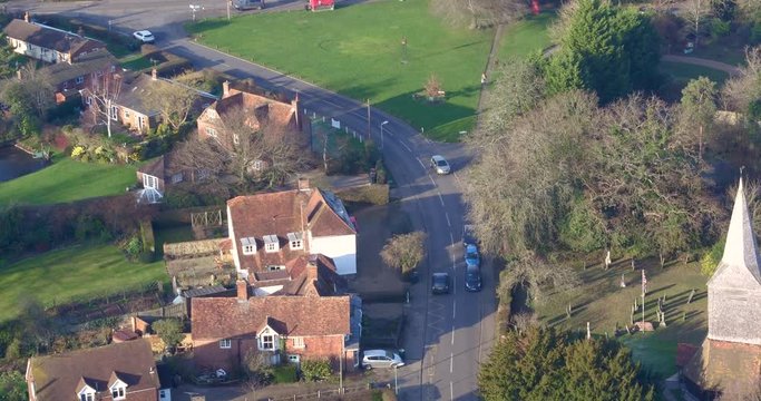 Aerial tracking shot of a commuter returning home, shot in High Halden village, located in Kent (The Garden Of England) UK