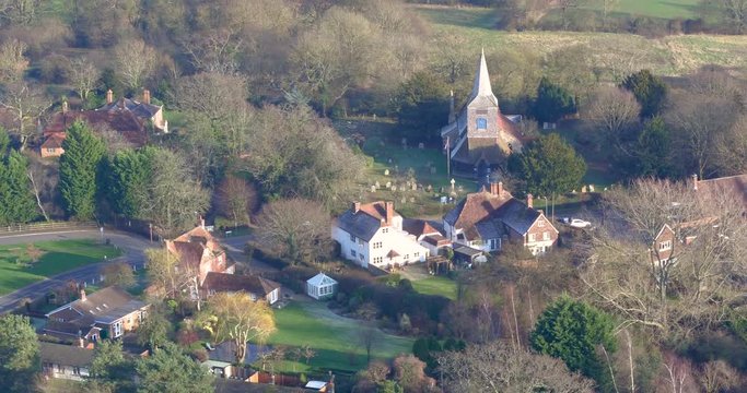 Aerial pullback from St Marys church in High Halden village, located in Kent (The Garden Of England) UK to reveal the British countryside.
