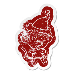 Fototapeta premium cartoon distressed sticker of a surprised monkey wearing santa hat