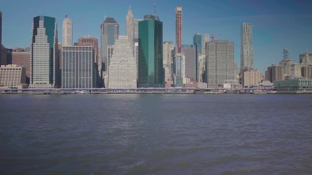 Slow reveal of World Trade Center overlooking the river and NYC skyline