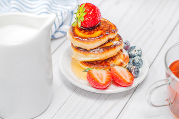 Healthy breakfast. Tea and delicious pancakes, with fresh blueberries, strawberries