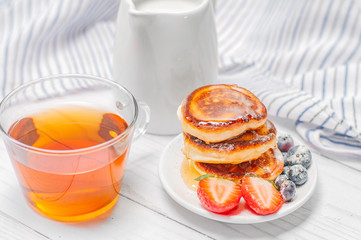 Healthy breakfast. Coffee and delicious pancakes, with fresh blueberries, strawberries
