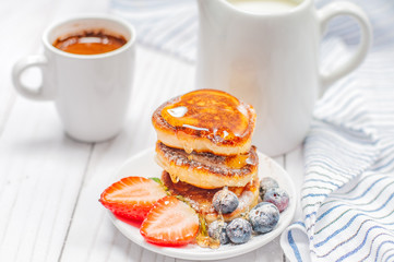 Healthy breakfast. Coffee and delicious pancakes, with fresh blueberries, strawberries
