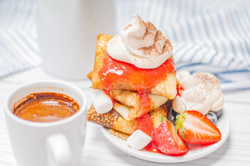 Healthy breakfast. Coffee and delicious pancakes, with fresh blueberries, strawberries