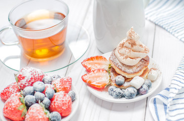 Healthy breakfast, black tea and  homemade pancakes with fresh berries