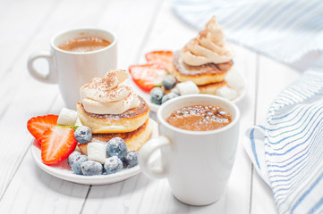 Healthy breakfast, coffee and homemade pancakes with fresh berries