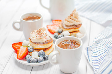 Healthy breakfast, coffee and homemade pancakes with fresh berries