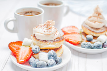 Healthy breakfast, coffee and homemade pancakes with fresh berries