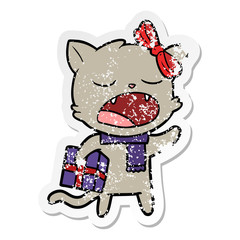 distressed sticker of a cartoon cat with christmas present