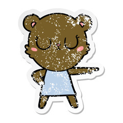 distressed sticker of a peaceful cartoon bear in dress pointing