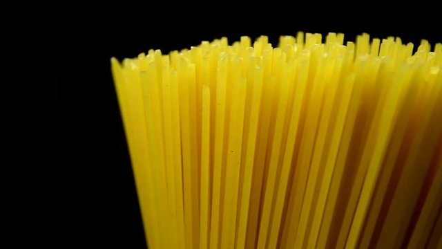Spaghetti rotating on black background in 4K resolution