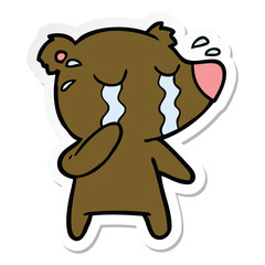 sticker of a cartoon crying bear