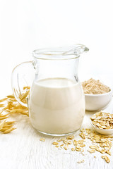 Milk oatmeal in jug on light board