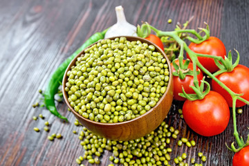 Mung beans  in bowl with vegetables and thyme on dark wooden board