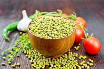 Mung beans  in bowl with vegetables and thyme on wooden board