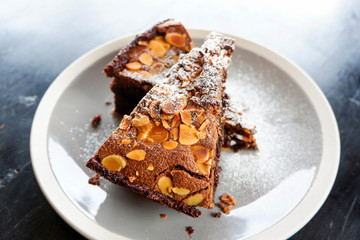 brownies cake on the table / piece of chocolate cake cocoa with nut and icing sugar