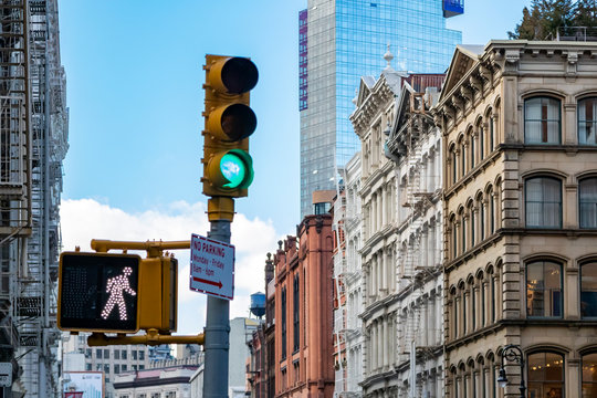 Traffic light and old buildings at an intersection on Broome Street in the SoHo neighborhood in Manhattan New York City