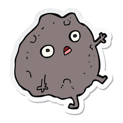 sticker of a cartoon rock falling