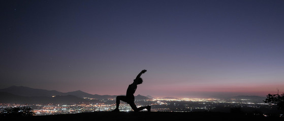 Man traveling the world, practicing yoga in the mountains, sunsets