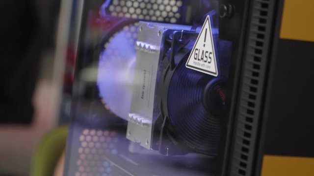 The inside of an illuminated gaming PC case in slow motion.
