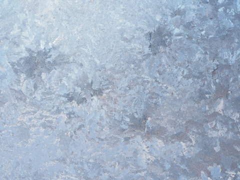 Light Blue and Gray Ice Crystals on a Window Pane