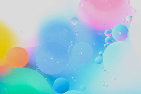 Blurred abstract background. Image of abstract blue, pink and yellow circles and drops of different sizes. Cropped shot, horizontal, blurred, free space, nobody