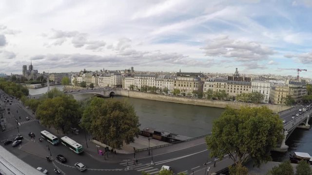 Rooftop timelapse in Paris with the church of Notre Dame in the background overlooking the Seine. Shot in 4k