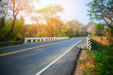 Asphalt road and concrete bridge at countryside in summer