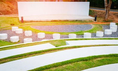 Stage outdoors / stage show with Park bench Cement and pathway in the garden