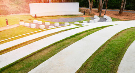 Stage outdoors / stage show with Park bench Cement and pathway in the garden