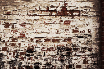 brick wall of old, red, rough brick with shabby white plaster