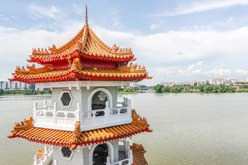 Naklejka premium The Twin Pagodas on Jurong Lake, in the Chinese Garden with cloudy sky in Singapore..