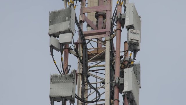 Telecommunication tower. Phone pole. Antenna on cloudy sky. Fibre-connected telecom tower. Cell phone and data communications tower. Ultra-high-speed data services background.