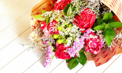 Fresh, lush bouquet of colorful flowers on white background. Happy birthday, valentines day or womens day of 8 march concept. Top view.
