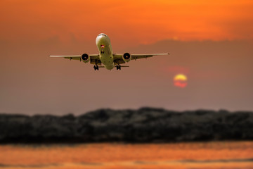 Passenger plane in flight. Aircraft fly high in the sky above the clouds. Front view of airplane.