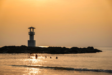 Image of small lighthouse against a tropical ocean sunset and smooth water at Khao Lak Beach in Phang Nga,Thailand. English translate;Khao Lak light beacon..