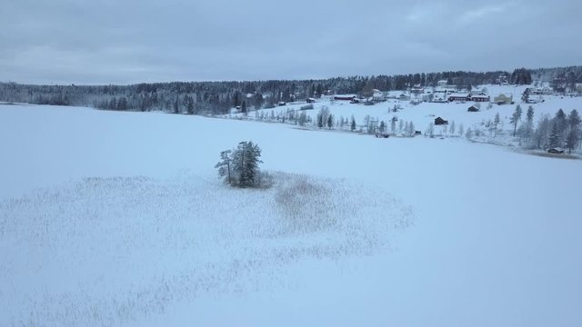 The frozen lake and forest near Borgvattnet, Sweden. Filmed with a drone during the day.