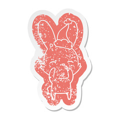 curious bunny cartoon distressed sticker of a wearing santa hat