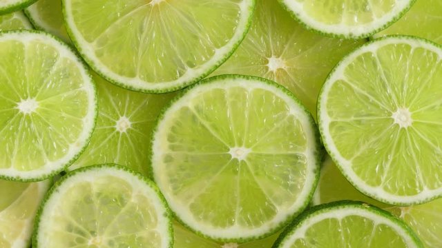Lime slices closeup, macro food summer background, fruits top view. Rotate