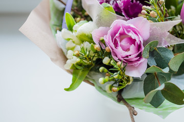 beautiful blossoming flower bouquet of fresh Quicksand roses, carnations, ranunculus, peony, branches with buds,first leaves on white background.Flowers for special occasion,event.Happy mother's day