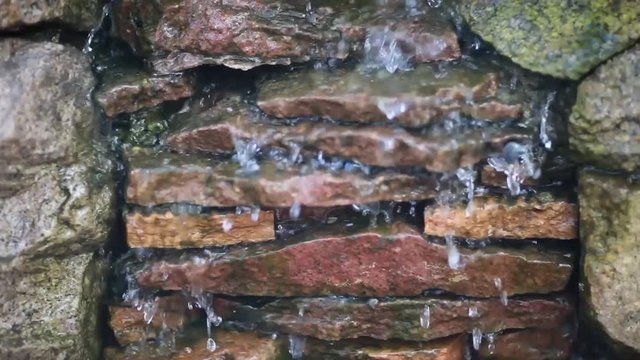 Water running through the stones, waterfall close up hd video
