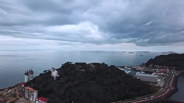 Aerial shot of city with sea and boats in the bay, 360 degree panning