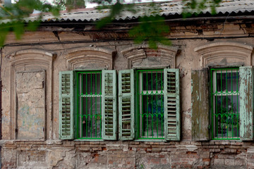 Fototapeta na wymiar Three windows on the facade of an old stone house. Rostov-on-Don. Russia.